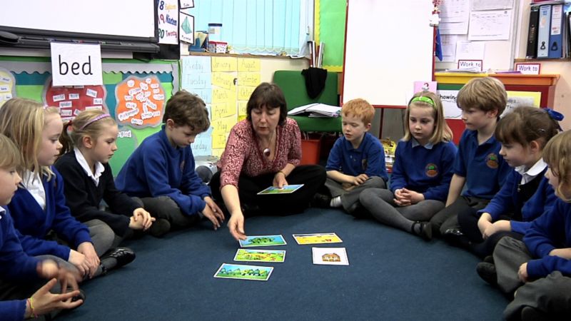 A teacher showing kids image cards